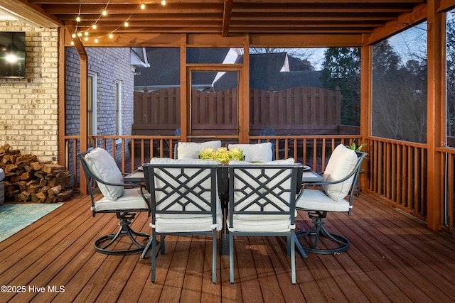 wooden terrace featuring outdoor dining space and fence