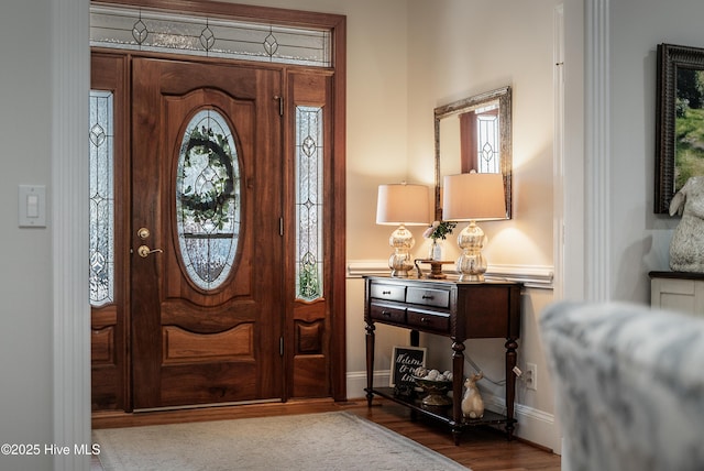 foyer entrance featuring wood finished floors and baseboards