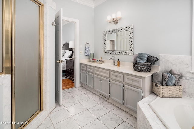 bathroom with tiled bath, ornamental molding, an enclosed shower, marble finish floor, and vanity