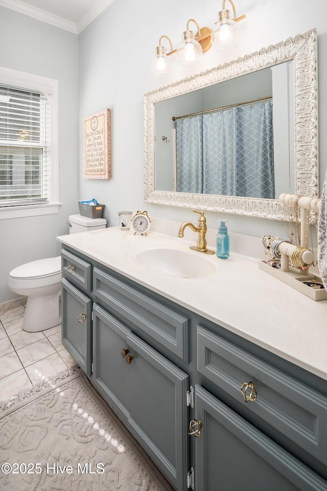 bathroom featuring tile patterned floors, toilet, vanity, and ornamental molding