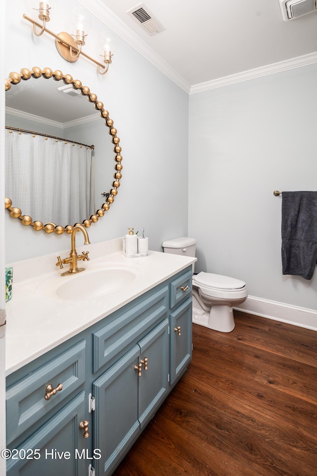 full bath with visible vents, ornamental molding, vanity, and wood finished floors