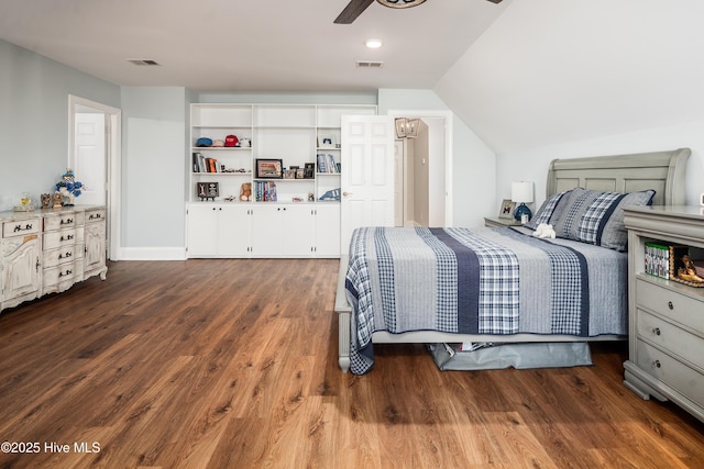 bedroom with visible vents, a ceiling fan, lofted ceiling, and wood finished floors