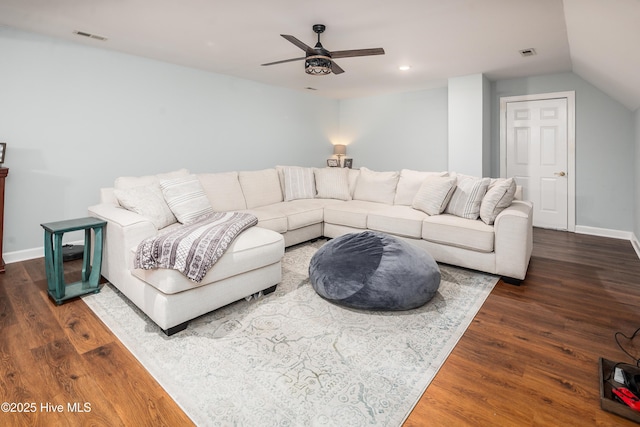 living room with ceiling fan, visible vents, and wood finished floors