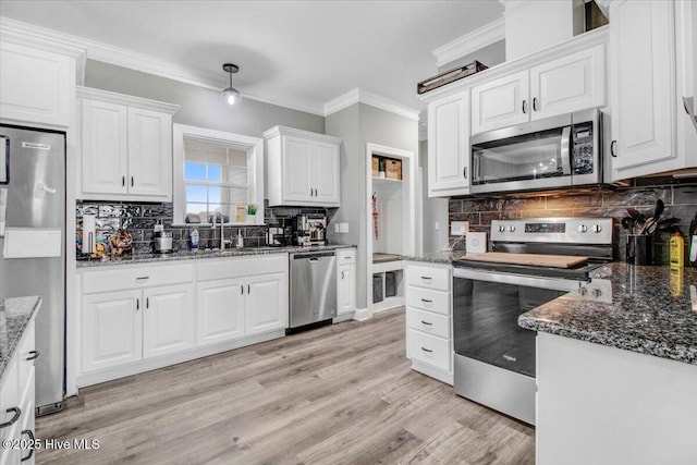 kitchen with light wood-style flooring, a sink, white cabinetry, stainless steel appliances, and crown molding