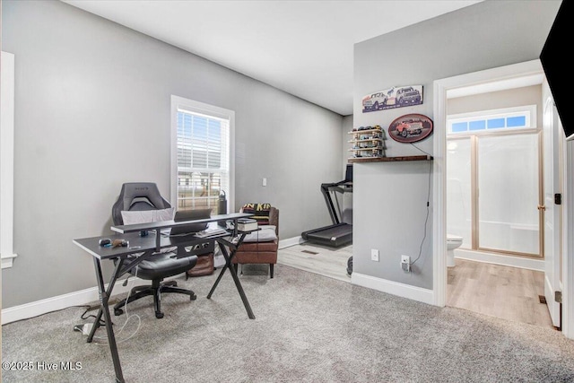 home office with wood finished floors and baseboards