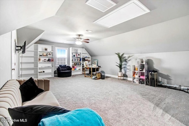 interior space with visible vents, baseboards, attic access, lofted ceiling, and carpet floors