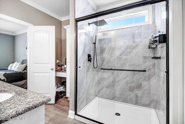 bathroom featuring a shower stall, ensuite bath, vanity, and ornamental molding