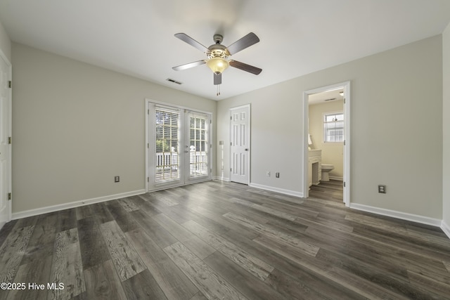 unfurnished bedroom featuring dark wood finished floors, access to exterior, multiple windows, and visible vents