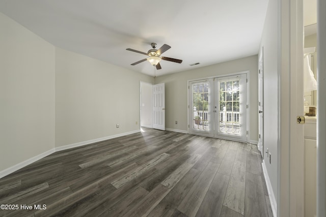 unfurnished room featuring visible vents, baseboards, ceiling fan, french doors, and dark wood-style floors