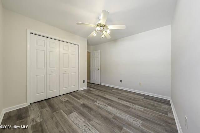 unfurnished bedroom featuring a closet, a ceiling fan, baseboards, and wood finished floors