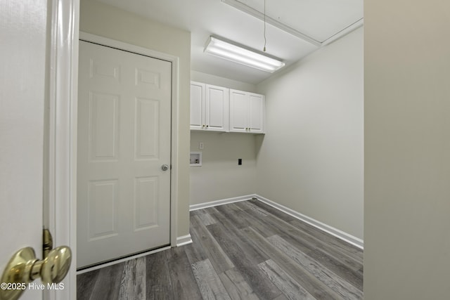 laundry room with hookup for a washing machine, baseboards, attic access, cabinet space, and dark wood-type flooring