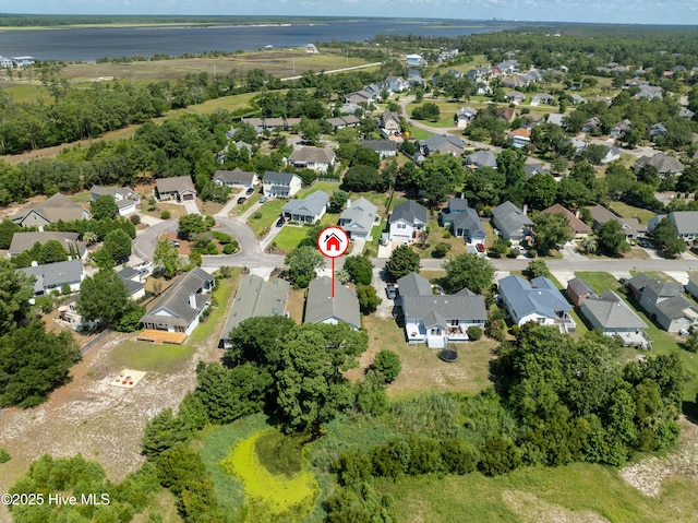 drone / aerial view with a residential view and a water view