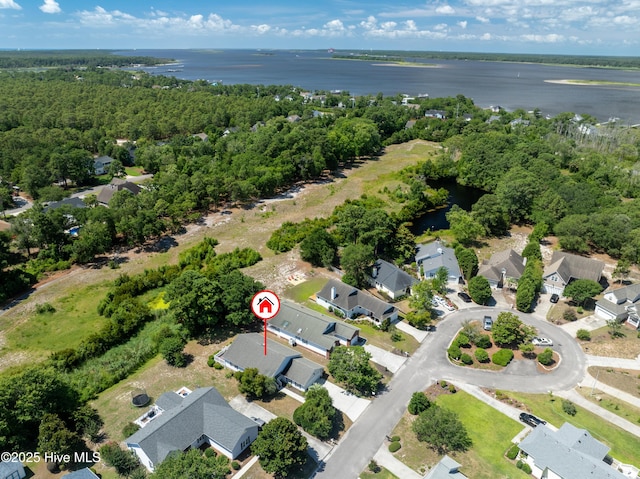 aerial view with a forest view and a water view