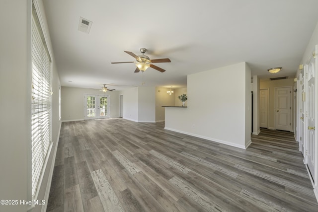 unfurnished living room featuring visible vents, baseboards, wood finished floors, and a ceiling fan