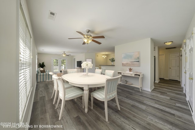 dining area featuring ceiling fan, visible vents, baseboards, and wood finished floors