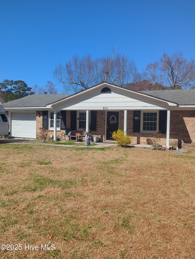 ranch-style home with brick siding, an attached garage, covered porch, and a front lawn