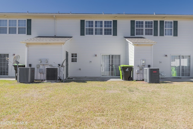 83 Crush Ct, Swansboro, NC 28584 - back of house with cooling unit and a lawn