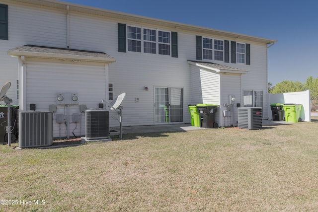 83 Crush Ct, Swansboro, NC 28584 - rear view of house featuring cooling unit and a yard