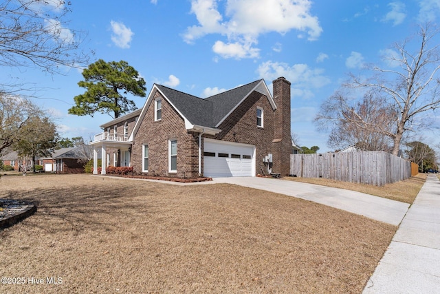 view of property exterior with fence, driveway, a chimney, a lawn, and brick siding