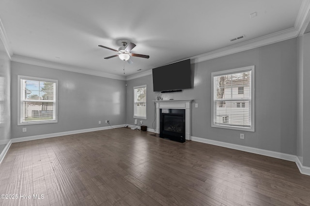 unfurnished living room with dark wood-style floors, a fireplace with flush hearth, and a healthy amount of sunlight