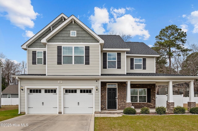 craftsman house featuring brick siding, driveway, and fence