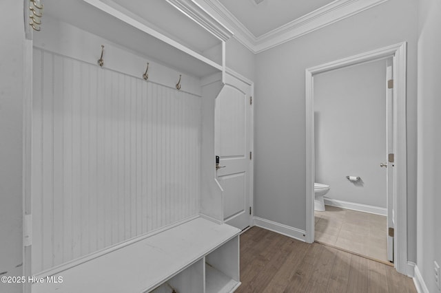 mudroom with wood finished floors, baseboards, and ornamental molding