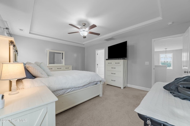 bedroom with visible vents, light carpet, a raised ceiling, a ceiling fan, and baseboards