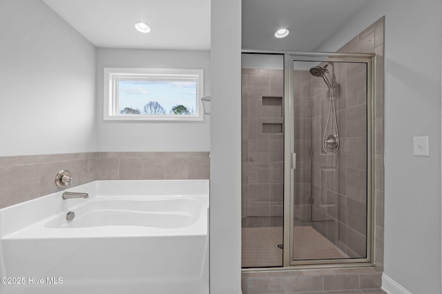 bathroom with a bath, recessed lighting, and a shower stall