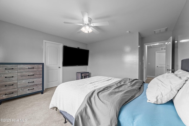 bedroom featuring visible vents, light colored carpet, and ceiling fan