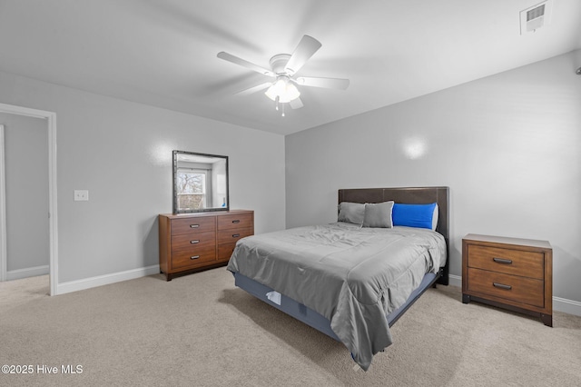 bedroom featuring baseboards, light colored carpet, and ceiling fan