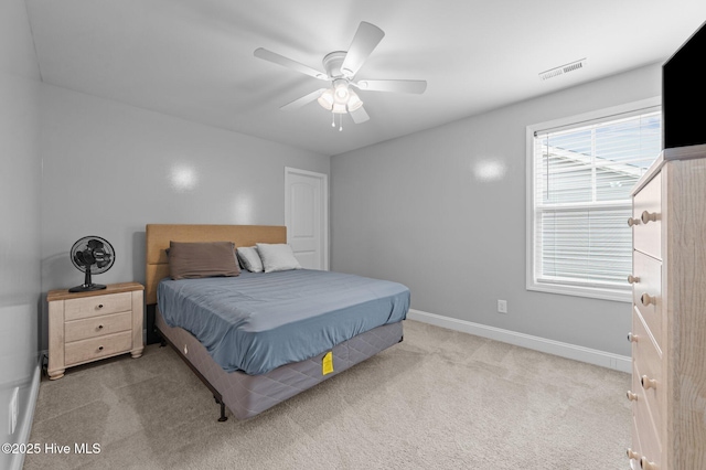 bedroom featuring visible vents, baseboards, carpet, and a ceiling fan