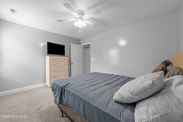 carpeted bedroom featuring baseboards, visible vents, and ceiling fan