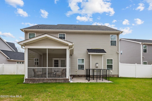 rear view of house with a patio area, a yard, a fenced backyard, and a sunroom