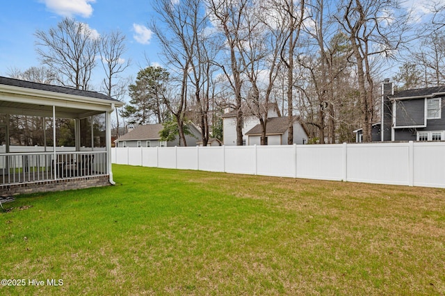 view of yard with a sunroom and fence