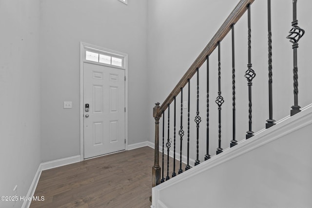 entryway featuring stairway, baseboards, and wood finished floors