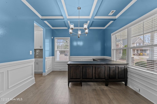 unfurnished office with visible vents, a chandelier, beamed ceiling, wood finished floors, and coffered ceiling