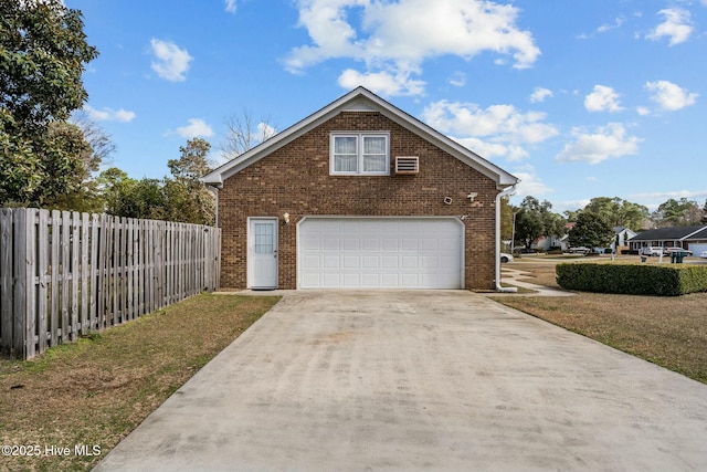 exterior space with concrete driveway and fence