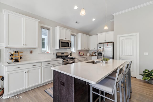 kitchen with visible vents, a sink, tasteful backsplash, appliances with stainless steel finishes, and white cabinets