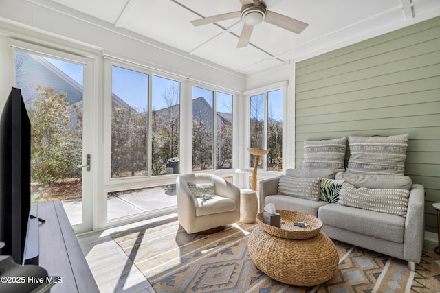 sunroom / solarium with a wealth of natural light and ceiling fan