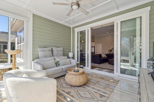 sunroom featuring a ceiling fan