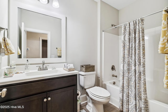 full bathroom featuring vanity, toilet, and shower / tub combo with curtain