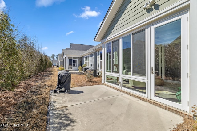 view of patio with a sunroom