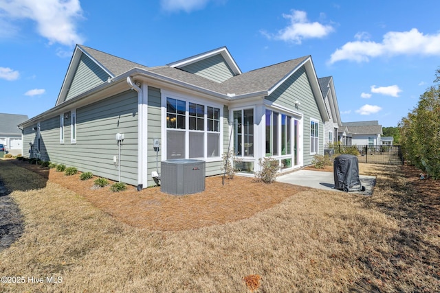 back of house with a patio, central AC unit, fence, and a shingled roof