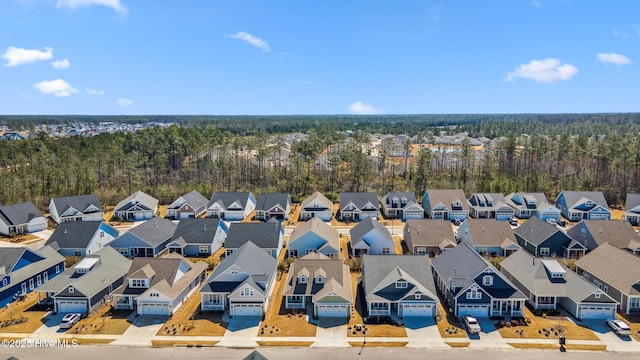 drone / aerial view with a residential view and a wooded view