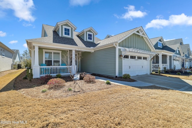 view of front of house featuring driveway, a porch, a shingled roof, a garage, and board and batten siding