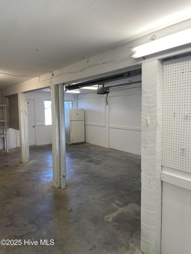 below grade area with freestanding refrigerator