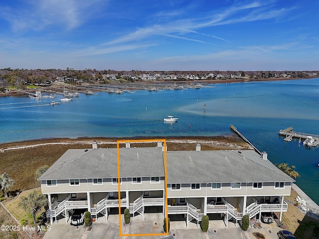 birds eye view of property with a water view