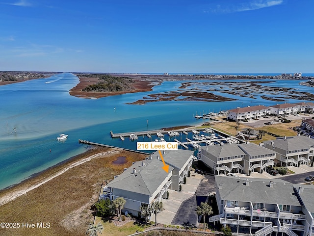 birds eye view of property featuring a water view and a view of the beach