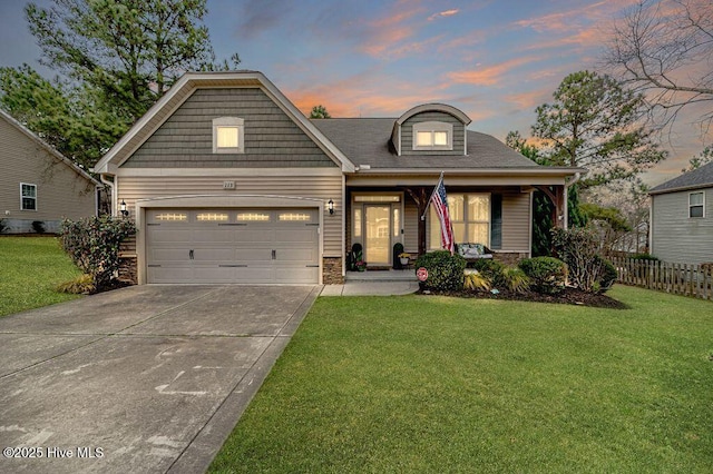 view of front facade with a front yard, an attached garage, fence, and driveway