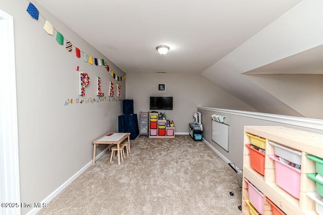 recreation room with baseboards, carpet floors, and vaulted ceiling